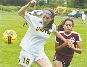  ?? Alex von Kleydorff / Hearst Connecticu­t Media ?? Weston’s Katie Orefice, left, brushes off a Bethel defender and gets to the ball during Thursday’s game in Bethel.