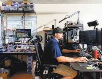  ?? Photos by Cayce Clifford / New York Times ?? Above: Aaron Loar, an engineer at Natron Energy, works from home in Berkeley. The firm is making a new kind of battery. Below: Dina Montiel sorts parts at Natron’s Santa Clara facility.