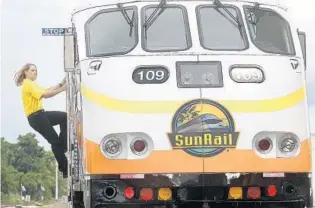  ?? RED HUBER/STAFF PHOTOGRAPH­ER ?? Christine Davis, 41, is one of three women recently selected to drive SunRail trains. “I try to get my head out there so they can see I’m a woman operating the train,” she said. “It’s something to be proud of.”