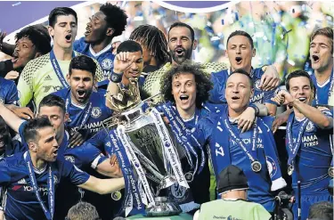  ?? Picture: REUTERS ?? THE CHAMPIONS: Jubilant Chelsea players celebrate with the trophy at Stamford Bridge yesterday after winning the English Premier League