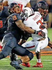  ?? [PHOTO BY NATE BILLINGS, THE OKLAHOMAN ARCHIVES] ?? SCOTT WRIGHT, Oklahoma State’s Justin Phillips (19) makes a stop against Texas Tech in the Cowboys’ 45-44 win at Boone Pickens Stadium last season.