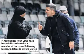  ?? Dan Mullan ?? > Argyle boss Ryan Lowe has a heated discussion with a member of the crowd following his side’s defeat to Oxford United