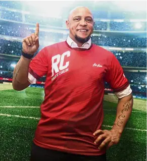  ?? — FAIHAN GHANI/ The Star ?? One and only: Brazil football legend Roberto Carlos posing in an AirAsia jersey after being unveiled as AirAsia’s global ambassador at a hotel in Kuala Lumpur yesterday.