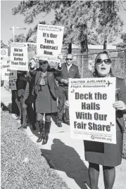  ?? Andrea Rumbaugh / Houston Chronicle file ?? United Airlines flight attendant Theresa Wallace protests near Bush Interconti­nental Airport late last year. The flight attendants union is the last major employee group without a joint contract at United.