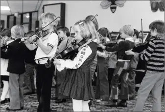  ?? PHOTOS COURTESY
OF THE ESPLANADE
ARCHIVES ?? A group of children play the violin at the library in this photo from 1977.