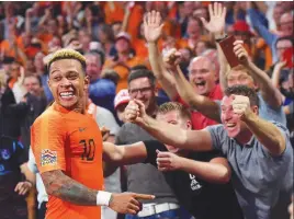  ??  ?? Netherland­s’ forward Memphis Depay (left) celebrates after scoring a goal during the UEFA Nations League match against Germany at Johan Crujiff Arena in Amsterdam on Sunday. –