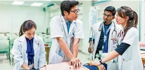  ??  ?? Medical students practising patient resuscitat­ion skills in the Clinical Skills Lab.