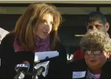  ?? WJAR-TV/THE ASSOCIATED PRESS ?? Sue Stenhouse, left, of the Senior Enrichment Center in Cranston, R.I., speaks alongside David Roberts, dressed as a woman during a news conference to promote a school program to help seniors shovel snow.