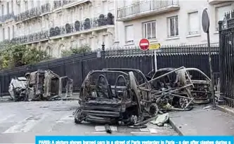  ??  ?? PARIS: A picture shows burned cars in a street of Paris yesterday in Paris - a day after clashes during a protest of Yellow vests (Gilets jaunes) against rising oil prices and living costs. —AFP