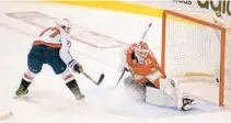  ?? MICHAEL LAUGHLIN/SUN SENTINEL ?? Washington’s T.J. Oshie puts the puck past Panthers goalie Sergei Bobrovsky in the third period Tuesday.