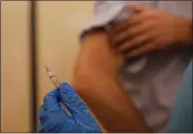  ?? ASSOCIATED PRESS FILE PHOTO ?? A nurse prepares to inject flu vaccine in Milan, Italy on Nov. 4.