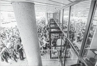  ?? GARY YOKOYAMA THE HAMILTON SPECTATOR ?? BTS fans lined up calmly and politely outside FirstOntar­io Centre. The Bay Street entrance opened at 6:10 p.m.