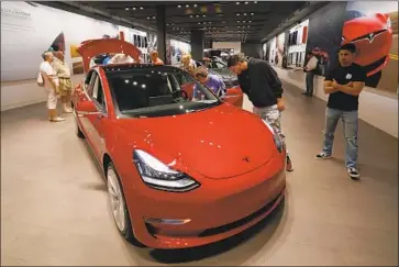  ?? David Zalubowski Associated Press ?? TESLA’S stock price hit $387.46 on Aug. 7 when Elon Musk tweeted he had “funding secured” to take the company private, which proved untrue and led to a stock plunge. Above, a Model 3 is displayed in a showroom.