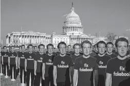  ?? AFP ?? 100 life-sized cutouts of Facebook CEO Mark Zuckerberg sit on the lawn of the US Capitol on Tuesday in Washington, DC. The advocacy group Avaaz placed the cutouts on the lawn to draw attention to the alleged hundreds of millions of fake accounts still...