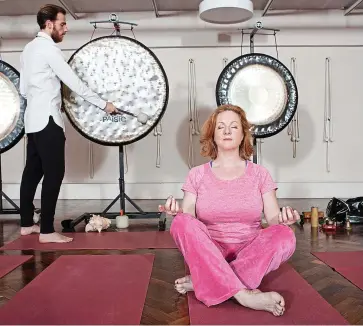  ??  ?? Gong-ho: Louise Atkinson tries out a gong bath from sound healer Leo Cosendai