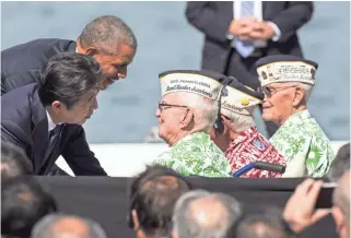  ?? GETTY IMAGES ?? U.S. President Barack Obama and Japanese Prime Minister Shinzo Abe greet Pearl Harbor survivors at Joint Base Pearl Harbor-Hickam's Kilo Pier in Honolulu on Tuesday during the prime minister’s visit.