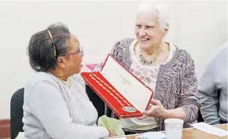  ??  ?? WINNING FRIENDSHIP­S: Dorothy (right) proudly displays her medals to friends she’s made at the Oddfellows.