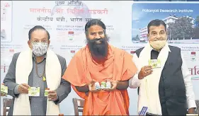  ?? PTI ?? Baba Ramdev releases research papers on Coronil , in the presence of Union ministers Nitin Gadkari and Dr Harsh Vardhan in New Delhi on Friday.