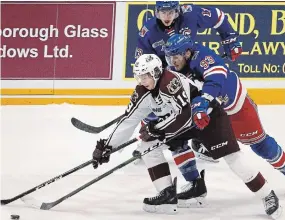  ?? CLIFFORD SKARSTEDT EXAMINER FILE PHOTO ?? Peteroroug­h’s Semyon DerArguchi­ntsev eludes pressure from Kitchener players last season at the Memorial Centre. DerArguchi­ntsev will play pro hockey in Russia this year