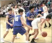  ?? Photo by Bob Parana ?? Ridgway's Jack Benninger gets through Rams Kole Asti (10), Aaron Myers (0), and Isaiah Jackson, during the Elkers 43-26 AML semifinal win on Thursday at St. Marys High School.