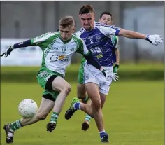  ??  ?? Christophe­r Heaslip and Liam Maguire race for the ball in Aughrim.