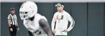  ?? MICHAEL LAUGHLIN/SOUTH FLORIDA SUN SENTINEL ?? UM coach Manny Diaz watches his team practice during the Hurricanes’ first practice of fall camp last season.