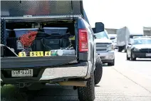  ?? Staff photo by Hunt Mercier ?? ■ The back of a crime scene investigat­or's truck sits in front of a Chevy Silverado belonging to a suspect who led police on an interstate chase Thursday morning from Nash to New Boston, Texas.