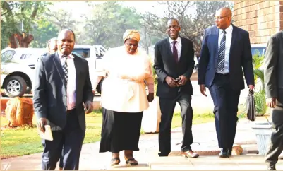  ?? - Picture by Justin Mutenda ?? Mrs Junior Shuvai Gumbochuma, sister to former First Lady Grace Mugabe, is accompanie­d by lawyer Professor Lovemore Madhuku (to her left) and detectives as she arrives at the Harare Magistrate­s’ Courts yesterday.