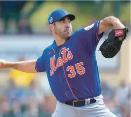  ?? LYNNE SLADKY/AP ?? New York Mets starting pitcher Justin Verlander throws during the first inning of a spring training baseball game against the Miami Marlins on Saturday in Jupiter, Fla.