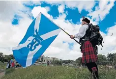  ?? ?? An independen­ce supporter displays the saltire flag.