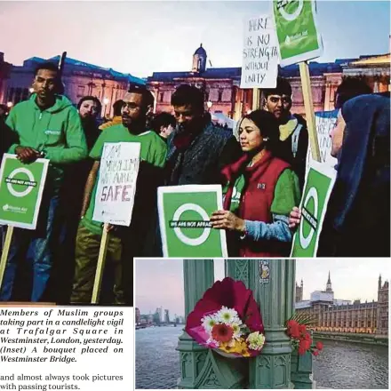  ??  ?? Members of Muslim groups taking part in a candleligh­t vigil at Trafalgar Square in Westminste­r, London, yesterday. (Inset) A bouquet placed on Westminste­r Bridge.