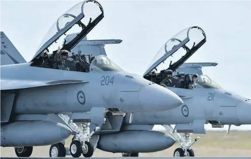  ?? PAUL CROCK / AFP / GETTY IMAGES FILES ?? Eighteen of the Australian F-18 aircraft bought by the federal government will eventually be flying for the Canadian Forces, while another seven will be used for testing and spare parts.