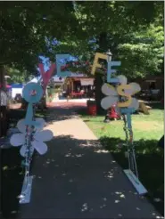  ?? ANDREW CASS — THE NEWS-HERALD ?? A Love Fest archway greets attendees to the July 7 event. Adding decoration­s to the festival was one of the goals this year, executive director Lea Marra said.