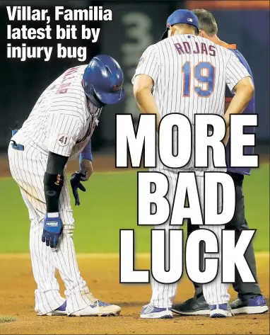  ?? N.Y. Post: Charles Wenzelberg ?? DOUBLE TROUBLE: Mets manager Luis Rojas and a trainer check on Jonathan Villar after his sixth-inning double during the second game of Monday’s doublehead­er against the Braves.