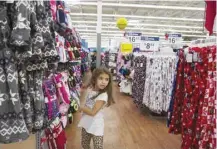  ?? — Reuters ?? A girl looks at pajamas while shopping at a Walmart store in Secaucus, New Jersey.