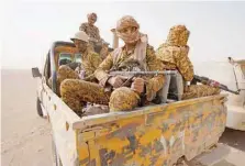  ?? — AFP ?? Fighters with forces loyal to Yemen’s government hold a position against Ansar Allah fighters in Yemen’s northeaste­rn province of Marib.