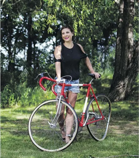  ?? DAVID BLOOM ?? MS ambassador Karma Deakin-Harb poses Friday with a specially designed bike that simulates the symptoms of multiple sclerosis. The rear wheel buckled when her husband tried to ride it.