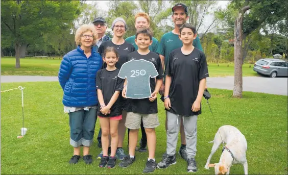 ?? PHOTO / SONETTE VAN ZYL ?? Daniel O’Sullivan holds a cutout to mark his 250th parkrun. Helping celebrate the milestone is, from back left, his grandfathe­r Graham Eagles, mother Jo, sister Jessie, father Mark, and front left grandmothe­r Gaynor Eagles, sister Rebecca, brother Michael and family dog Daffy.
