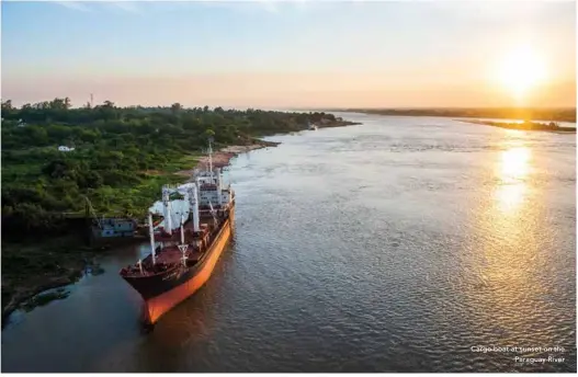  ??  ?? Cargo boat at sunset on the
Paraguay River