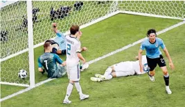  ??  ?? Uruguay's Edinson Cavani scores his side's third goal during the group A match with Russia