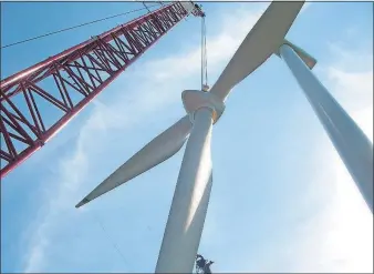  ?? [ONE ENERGY] ?? A crane is used to install a wind turbine for a project by One Energy, a Findlay company that develops wind projects for homes and businesses.