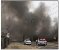  ?? NWA Democrat Gazette/Charlie Kaijo ?? Firefighte­rs monitor the scene Saturday at a blaze consuming a 70,000-square-foot warehouse at 659 E. Randall Wobbe Lane in Springdale.