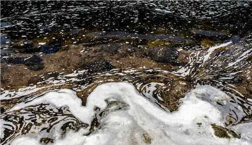  ?? Jake May/The Flint Journal via AP ?? File, 2018 - PFAS foam gathers at the the Van Etten Creek dam in Oscoda Township, Michigan, USA.