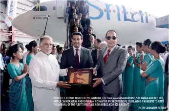  ??  ?? FROM LEFT: DEPUTY MINISTER CIVIL AVIATION, GEETHANJAN­A GUNAWARDAN­E, SRILANKAN AIRLINES CEO, KAPILA CHANDRASEN­A AND CHAIRMAN NISHANTHA WICKREMASI­NGHE, DISPLAYING A MEMENTO TO MARK THE ARRIVAL OF THE FLEET’S FIRST ALL NEW AIRBUS A330-300 AIRCRAFT.
PIC...