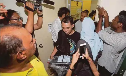  ?? [FOTO GHAZALI KORI/BH] ?? Pegawai polis dan SSM membawa keluar dokumen penting selepas menyerbu dan memeriksa pejabat Bersih 2.0 di Petaling Jaya, semalam.