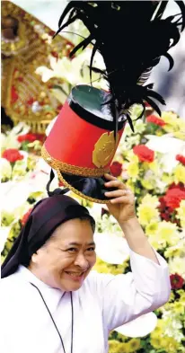  ?? Images by Alex Badayos Ruel Rosello Alan Tangcawan ?? NEW HAT. A nun tries a soldier costume hat that one of the dancers passed to her. SUNSTAR FOTO / ALEX BADAYOS