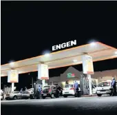  ?? PHOTO: ITUMELENG ENGLISH ?? Motorists are attended to by staff at an Engen garage. The company is in discussion­s with unions about possible job cuts to streamline its business.