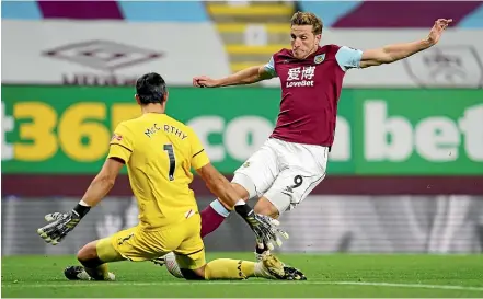  ?? GETTY IMAGES ?? Burnley’s Chris Wood takes the ball past Southampto­n goalkeeper Alex McCarthy to score, but was ruled offside. Below: Wood and fellow players take a knee in support of the Black Lives Matter movement.