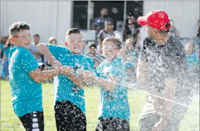  ?? Nikolas Samuels/The Signal ?? Students at Santa Clarita Elementary School in Saugus pull the string causing a bottle rocket to launch on Friday. Nearly 70 students designed, tested, decorated and launched bottle rockets as part of a science project.