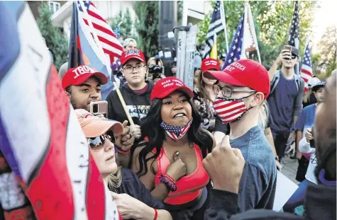  ?? PHOTO: REUTERS/JIM URQUHART ?? Split: Trump supporters argue with Biden supporters outside the 2020 vice presidenti­al debate between Mike Pence and Kamala Harris, at the campus of the University of Utah in Salt Lake City, Utah.